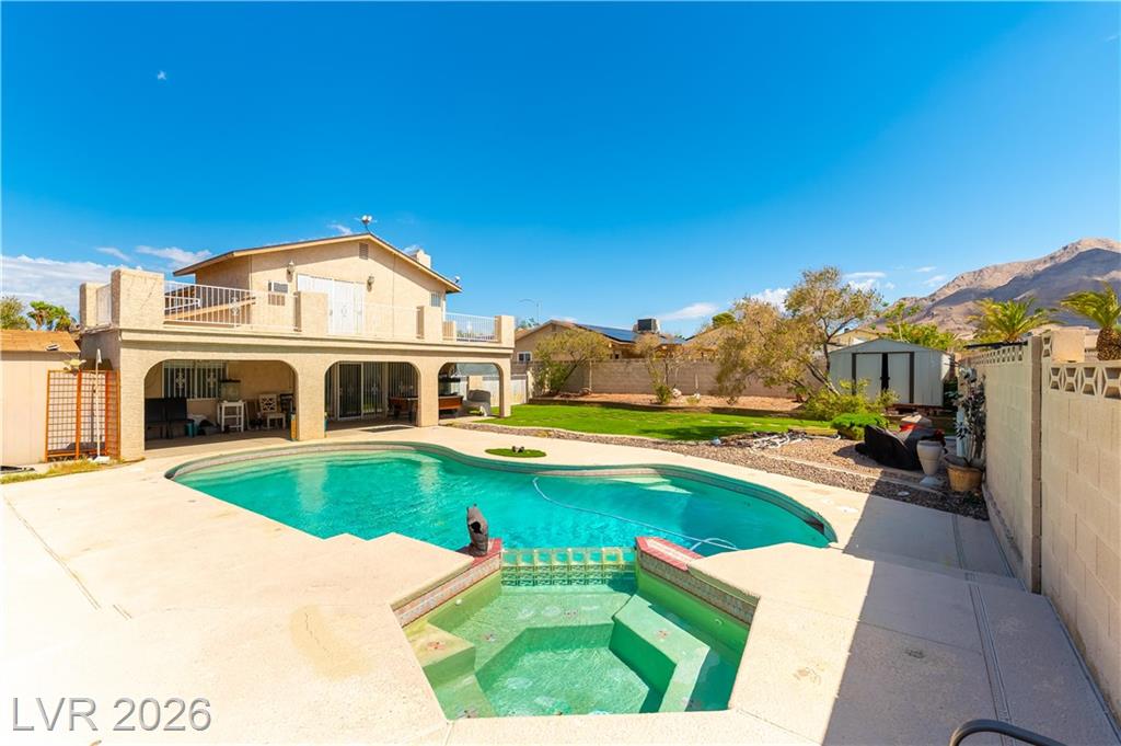 Pool and spa with the two-story home beyond